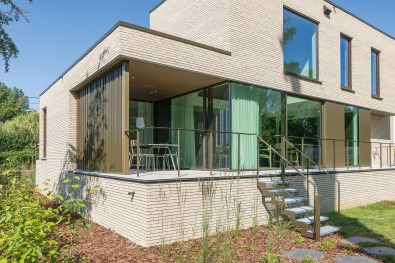 Arrière d'une maison à ossature bois à Rotselaar